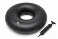 Inflatable donut ring cushion in dark blue with velvet cover and hand pump on white background