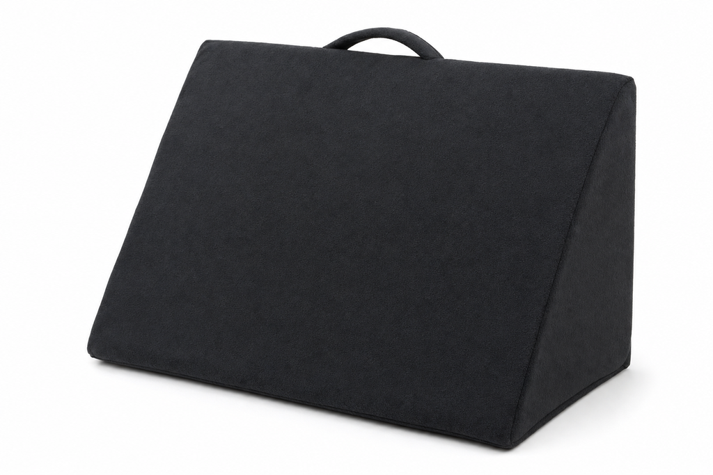 Gray triangular wedge cushion with bamboo cover and adjustable strap on white background