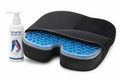 Black memory foam cushion topped with translucent blue honeycomb gel and coccyx cutout on white background