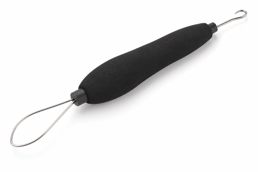 Combination button hook and zipper pull tool with black foam grip and metal wire loop on white background